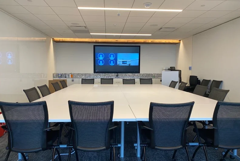 Large boardroom with projection screen and AV setup